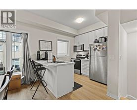 A well-lit kitchen with a dining table and chairs.