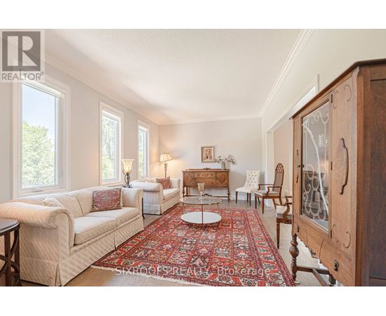 A living room with a rug and a wooden cabinet.
