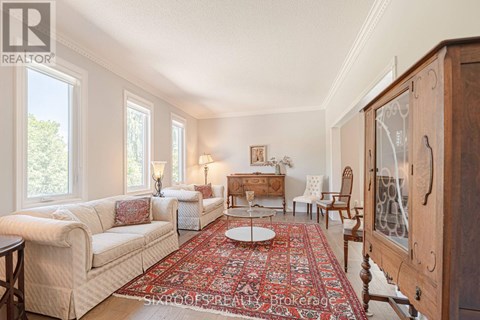A living room with a rug and a wooden cabinet.