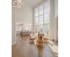 A well-lit dining room with a table and chairs.