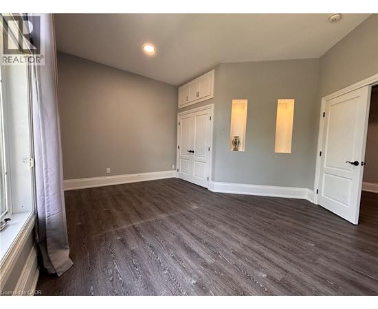 A room with grey flooring and white walls.