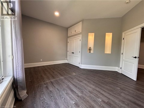 A room with grey flooring and white walls.