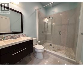 A bathroom with a toilet, sink, and shower.