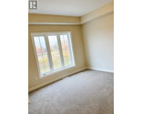 A room with a window and carpeted floor.