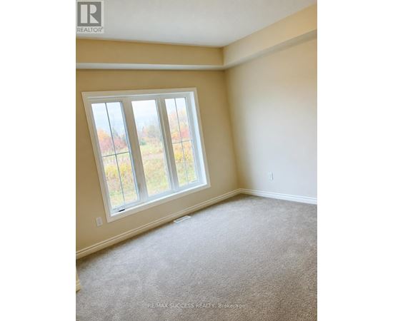 A room with a window and carpeted floor.