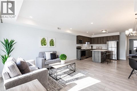 A modern living room with a grey couch and a coffee table.