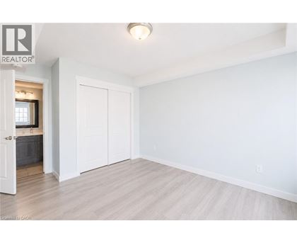 A white bedroom with a large closet and a doorway leading to a bathroom.