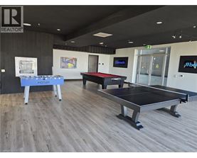 A room with a pool table and a billiard table.