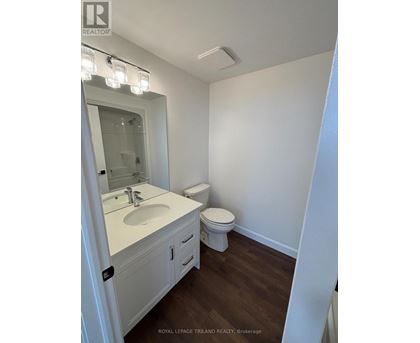 A white bathroom with a toilet and sink.