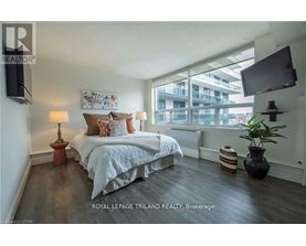 A bedroom with a large bed and a flat screen TV mounted on the wall.