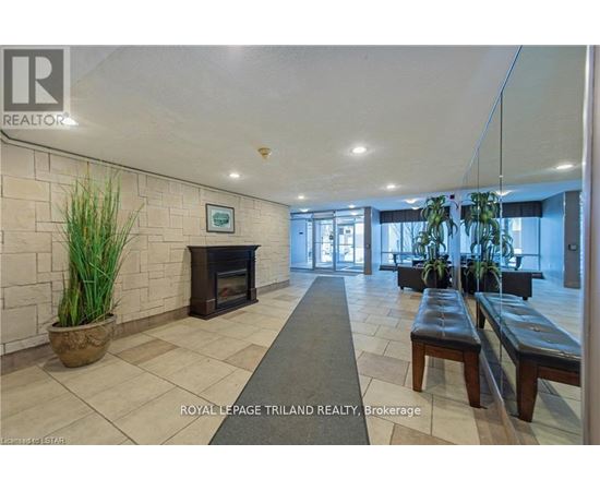 A spacious lobby with a fireplace and seating area.