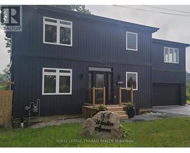 A blue house with a sign that says "16 Winston Avenue" in front of it.