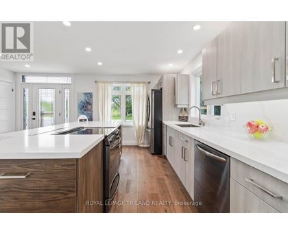 A modern kitchen with wooden cabinets and stainless steel appliances.