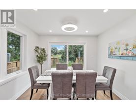A dining room with a table set for six.