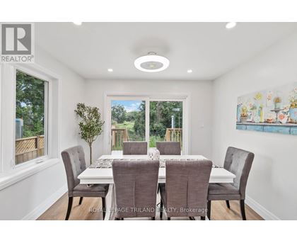 A dining room with a table set for six.