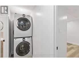 A white washing machine and dryer in a small room.