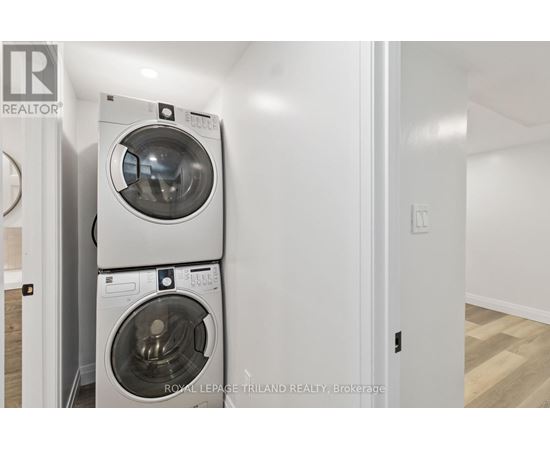 A white washing machine and dryer in a small room.
