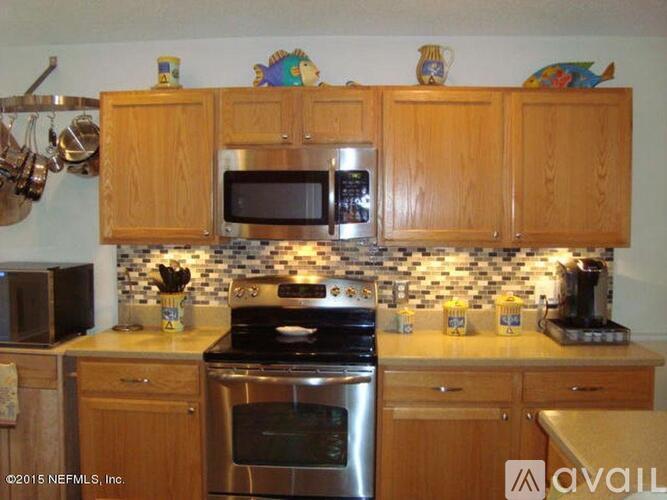 A kitchen with wooden cabinets and a black oven.