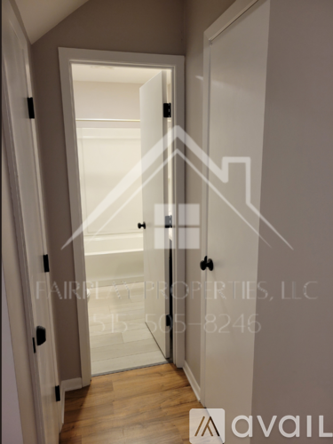 A hallway with a glass door leading to a bedroom.