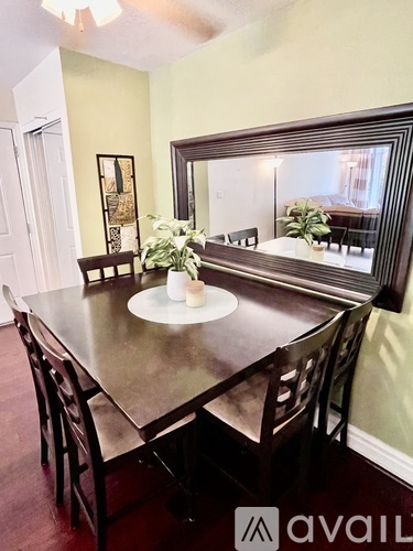 A dining room with a table and chairs.