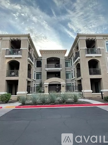 A large building with a balcony and a logo that says "avaiL" on the ground in front of it.