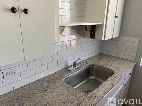 A kitchen with a sink and cabinets.