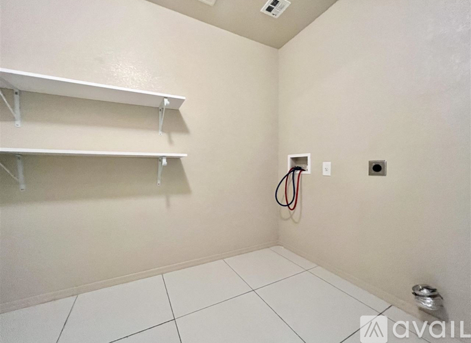 A room with white shelves and a white floor.