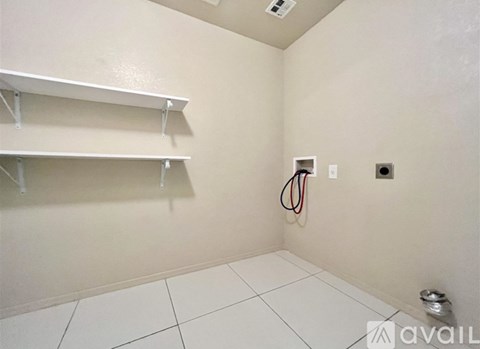 A room with white shelves and a white floor.