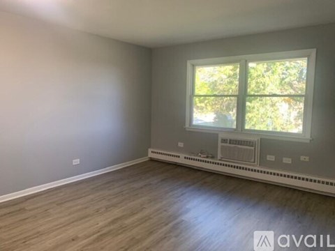 A room with a window and a radiator on the wall.