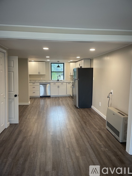 A kitchen with a washer and dryer in the wall.
