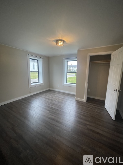 A room with wooden floors and a white door.