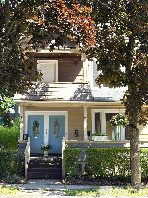 A house with a blue door and a white window.