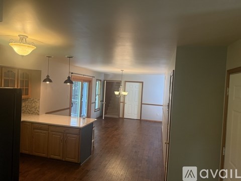 A kitchen with a wooden floor and a large island in the middle.