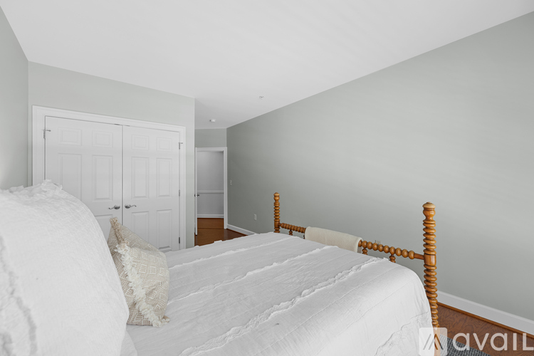 A bedroom with a large bed and a white door.