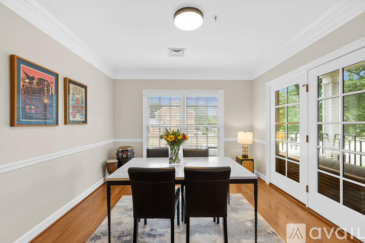 A dining room with a table and chairs.