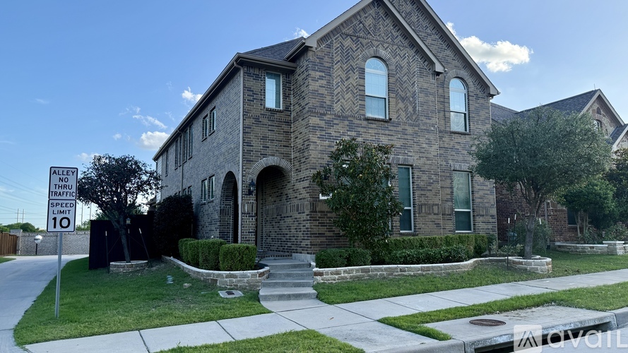 A house with a sign in front of it that says "Alley Traffic 10 Limit".
