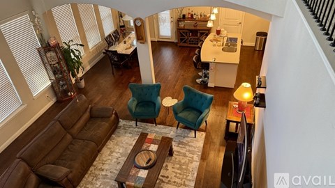 A living room with a brown leather couch and a wooden coffee table.