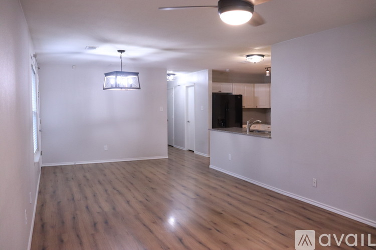 A room with wooden flooring and a ceiling fan.