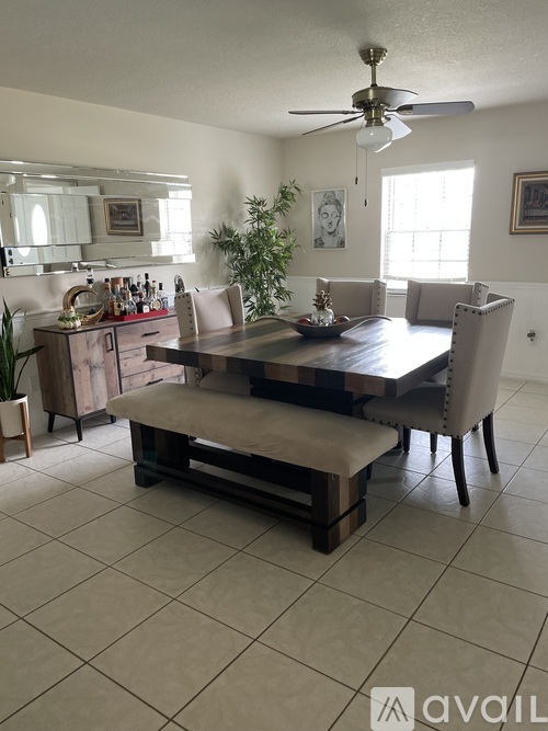 A dining room with a wooden table and chairs.