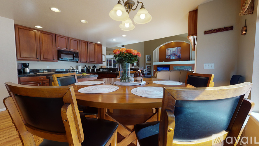 A dining room with a table set for two.