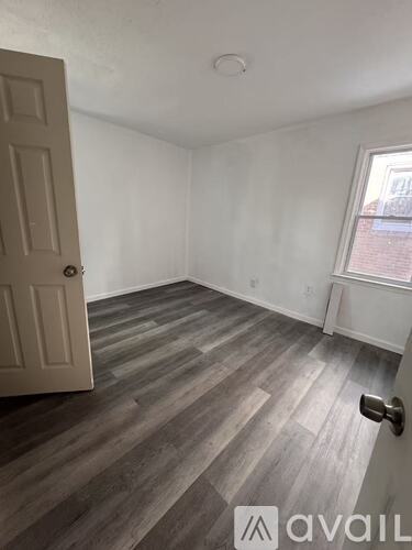 A room with a door and a window is available for rent.