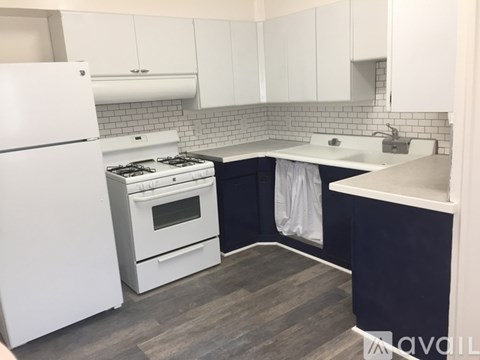 A kitchen with a white refrigerator and a white stove top oven.