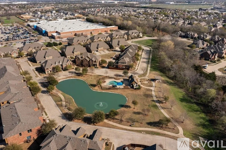 A bird's eye view of a residential area with houses and a swimming pool.