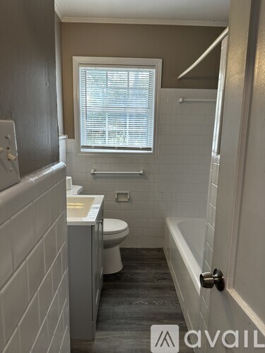 A bathroom with a toilet, sink, and bathtub.