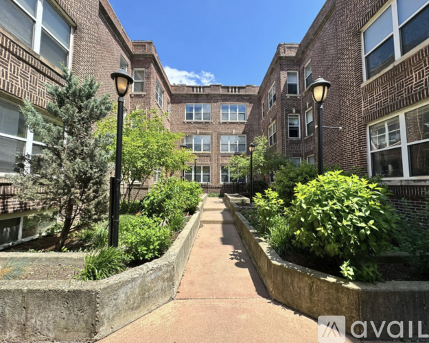 A sunny day in a courtyard surrounded by brick buildings.