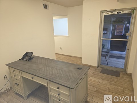 A room with a desk and a window.
