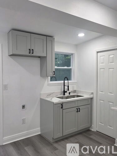 A kitchen with a sink and cabinets.