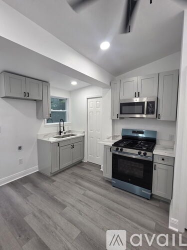 A kitchen with a stove top oven and a microwave.