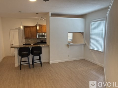 A kitchen with a bar area and two chairs.