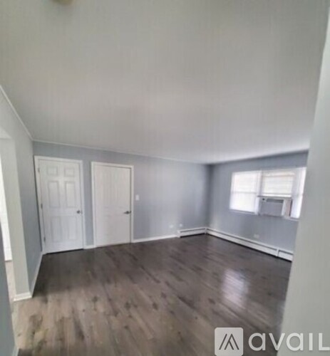 A room with wooden floors and white walls.